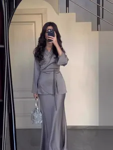 Elegant grey satin two-piece long skirt set featuring a wrap top with waist tie for women
