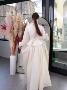 Elegant cream long-sleeved maxi dress with cinched waist lace-up back design