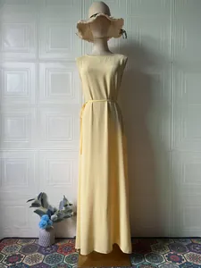 Front view of sleeveless yellow summer maxi dress on a headless mannequin