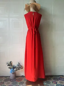 Elegant red sleeveless maxi dress with a sophisticated back tie detail and high neck