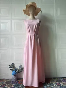 Full-length view of a sleeveless pink maxi dress with waist tie displayed on a mannequin