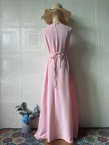 Detail view showing the elegant back and tie-waist design of pink sleeveless maxi dress