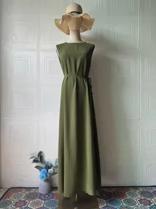 Olive green sleeveless maxi dress with waist tie shown on mannequin against white wall
