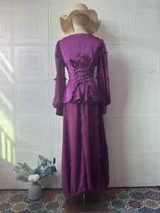 Back view of elegant purple long-sleeved retro maxi dress featuring lace-up waist detail