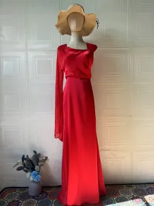Elegant red silky long-sleeve maxi dress with draped pleated bodice and slim fit design