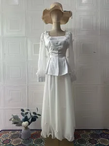 Full view of an elegant white two-piece dress with floral accents shown on a mannequin