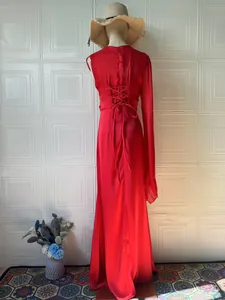 Detailed back view of an elegant red silky maxi dress with lace-up corset tie
