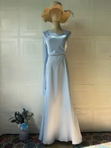 Elegant light blue silky long sleeve maxi evening dress professionally displayed on a mannequin