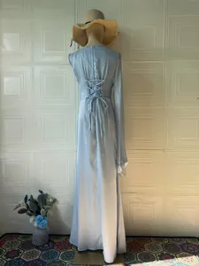 Back detail of elegant light blue silky maxi dress with corset lace-up design.