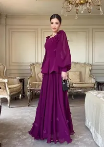 Model posing in an elegant vintage purple long-sleeve maxi dress set with florals