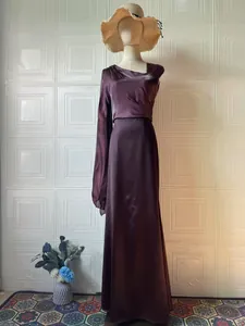 Detailed view of dark purple silky maxi dress with elegant flowy silhouette