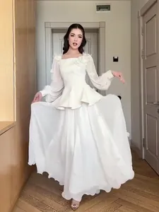 Elegant white long sleeve two-piece maxi dress set shown in a full-length model view