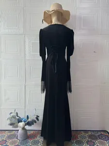 Back view of elegant black vintage velvet dress with lace-up detail and lace cuffs