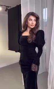 Elegant black velvet vintage dress featuring puff sleeves and a sophisticated square neckline.