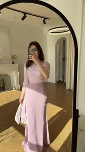 Full-length view of an elegant pink one-shoulder long dress with a flowing cape detail