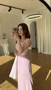 Detailed mirror selfie showing the elegant pink silky slim-fit maxi dress texture.