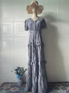 Elegant vintage floral maxi dress with short sleeves and ruffled layers on a mannequin