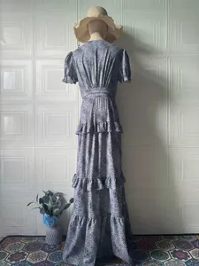 Back view of vintage floral tiered maxi dress with ruffled hem and puff sleeves
