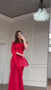 Full-length view of an elegant red one-shoulder dress with silky flowing fabric.