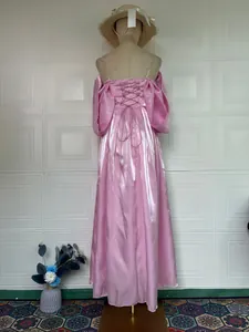 Back view of shiny pink off-shoulder princess gala dress with corset lace-up detail
