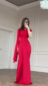 Detailed view of luxury elegant red silk-like slim fit maxi dress with asymmetric sleeve