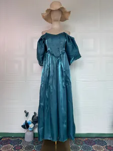 Detailed view of an elegant teal satin evening gown featuring puff sleeves and corset bodice
