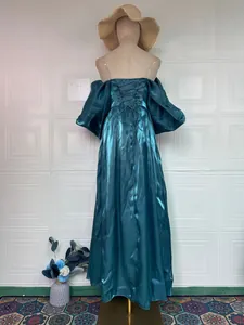 Back detail of a luxurious teal satin princess evening gown with corset lace-up