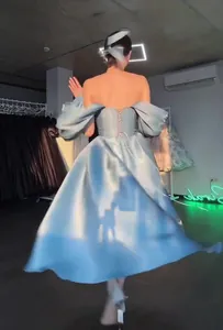 Macro view of a light blue off-shoulder princess dress showing the elegant corset back detail.