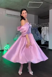 Elegant pink satin off-the-shoulder princess prom dress featuring voluminous puff sleeves.
