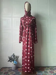 Full view of an elegant floral maxi dress displayed on a mannequin in a bright room