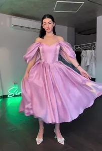 Elegant pink off-the-shoulder princess evening dress with puff sleeves.