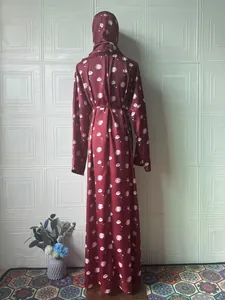 Back view of an elegant maroon long-sleeved floral printed maxi dress with matching hijab
