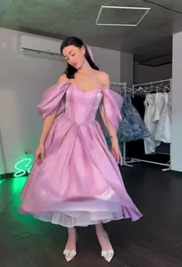 Detailed view of this lilac off-shoulder princess gown featuring elegant puffy sleeves