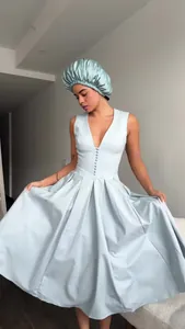 Full view of elegant light blue V-neck sleeveless pleated maxi dress worn by a model
