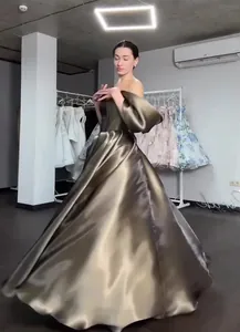 Detail view of luxury metallic bronze ball gown with voluminous sleeves and full skirt.