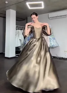 Elegant bronze off-the-shoulder evening gown with shimmering satin-like fabric texture detail
