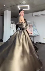Elegant metallic bronze princess evening gown with flowing satin skirt details