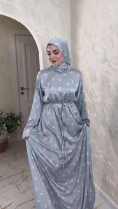 Detail of elegant light blue floral print satin maxi dress with matching hijab