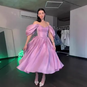 Elegant pink off-the-shoulder princess style evening gown with puff sleeves and full skirt