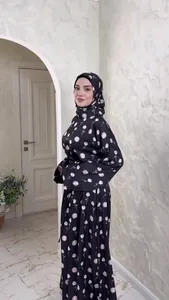 Elegant black long-sleeved maxi dress with pink floral print and matching hijab