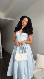 Close-up detail of an elegant light blue V-neck sleeveless maxi dress for women