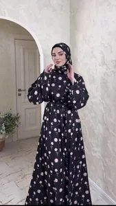 Elegant black floral print long sleeve maxi dress with matching hijab on a model