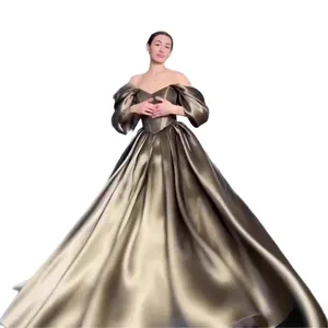 Elegant off-shoulder metallic evening gown with puffy sleeves and a voluminous skirt