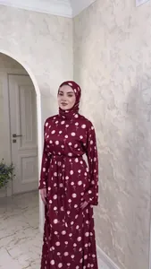 Full-length view of a maroon floral modest dress with matching headscarf and tie-waist