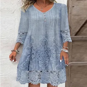 Detail view of light blue plus size dress with lace hem and vintage embroidery pattern