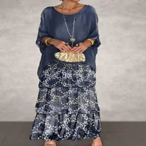 Elegant two-piece women's casual summer outfit featuring a blue top and floral tiered maxi skirt