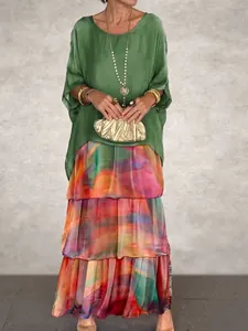 Bohemian style two-piece set featuring green loose top and colorful tiered maxi skirt