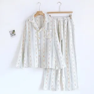 Close-up detail of women's floral and striped cotton pajama set featuring long sleeves and pants