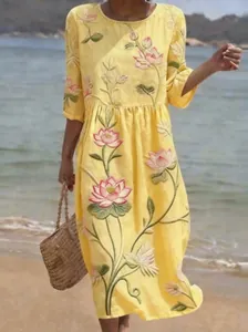 Close-up detail of the vibrant lotus flower embroidery on this yellow midi summer dress