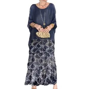 Bohemian style two-piece set featuring a loose blue top and tiered floral maxi skirt